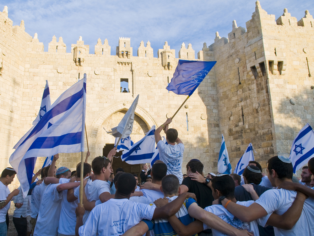 Israeli Nationalists wave national flags during a march marking Jerusalem Day